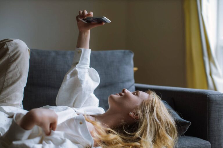 woman-in-white-dress-shirt-holding-a-smartphone