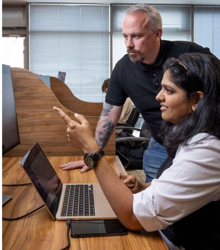 Corrata Staff Working on a computer together.